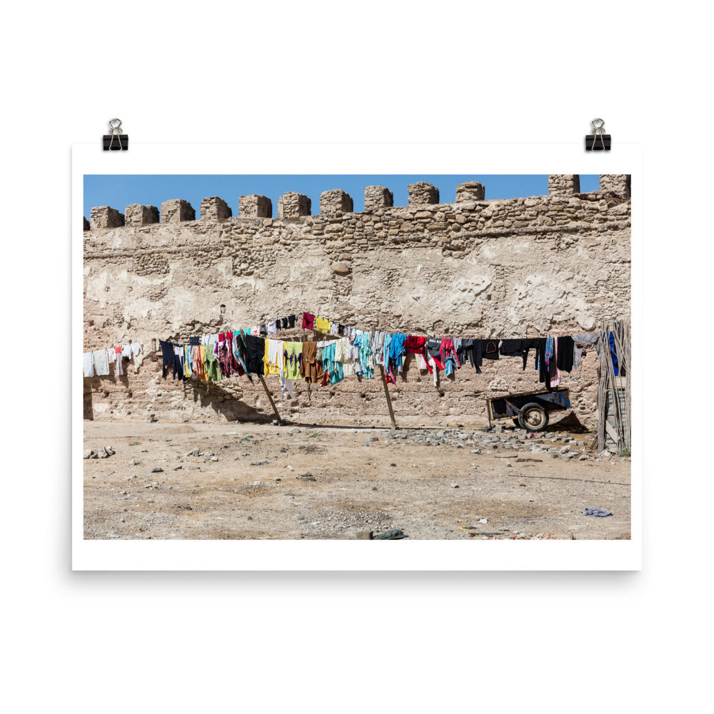 Wall art color photography print poster of Clothes hanging on a wire in front of a ruin in Essaouira, Morocco Africa