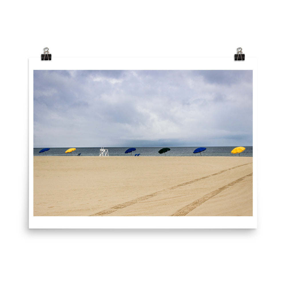 Wall art color photography print poster of a beach with umbrellas in Nantucket Massachussets with dramatic sky lights